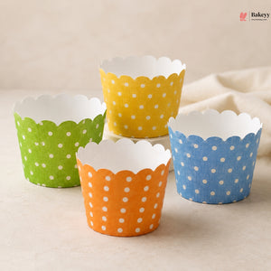 Four colorful polka dot cupcake liners on a beige surface with 'Bakery' branding.