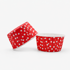 Two red paper cups with white polka dots on a white background