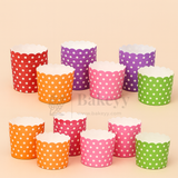 Colorful polka dot cupcake liners on a beige background