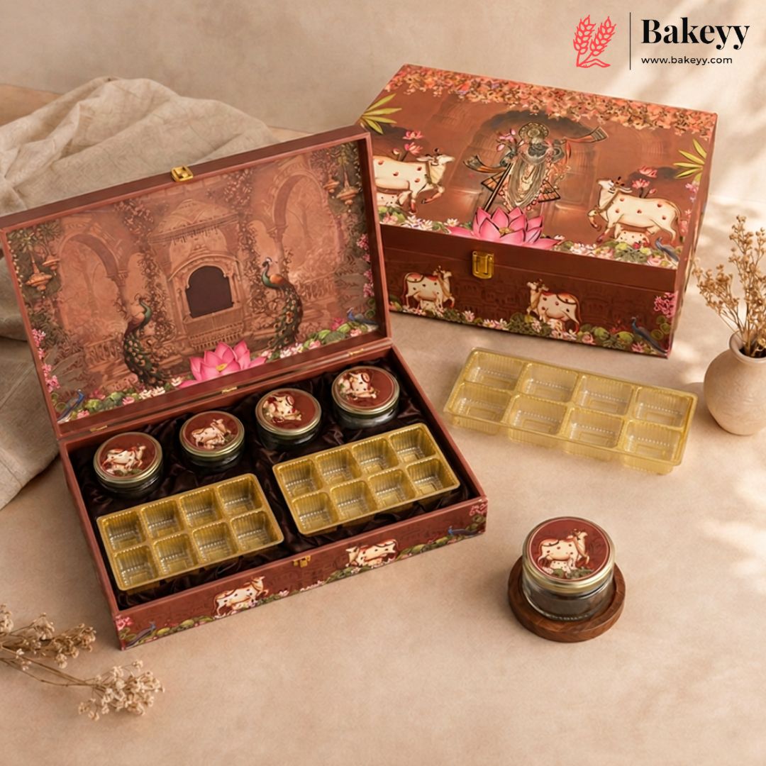 A decorative brown gift box set for a bakery, shown open with several small round jars and yellow grid trays inside, plus the closed box and extra trays on a beige fabric surface. The boxes feature illustrated artwork with cows, flowers, and a lotus motif.