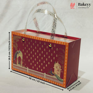 A decorative red and orange bakery gift box with clear handles, shown with dimension arrows and labels indicating 26 cm length, 16.5 cm height, and 9.