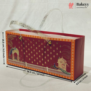A decorative red and orange gift box with printed peacock and architectural motifs, shown with dimension arrows and labels indicating 36.5 cm length, 16.