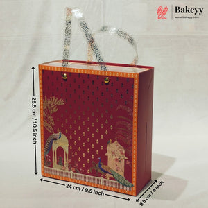 A decorative red gift bag with gold patterned handles and a peacock illustration on the front, shown with dimension lines indicating 26.5 cm height, 24 cm width, and 9.