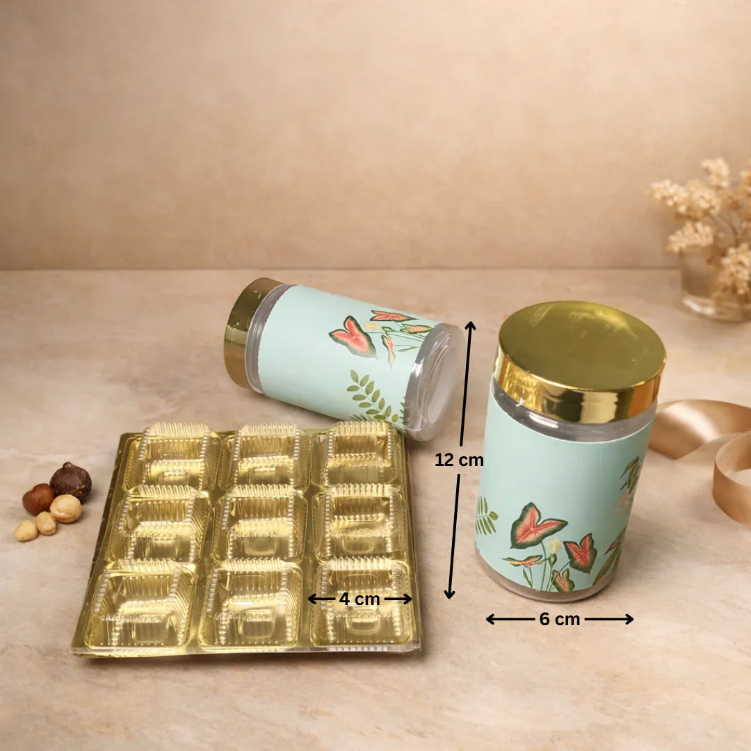 Luxury rigid gift box with botanical floral print
2 printed jars with premium gold lids
9-cavity tray ideal for sweets/chocolates
Ideal for dry fruits, chocolates, mithai, cookies and more
Strong build and premium look for festive gifting