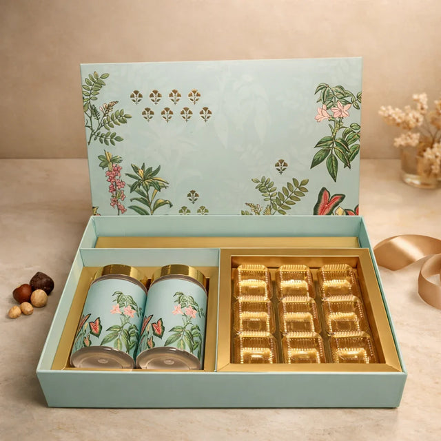 Luxury rigid gift box with botanical floral print
2 printed jars with premium gold lids
9-cavity tray ideal for sweets/chocolates
Ideal for dry fruits, chocolates, mithai, cookies and more
Strong build and premium look for festive gifting