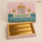 A pink decorative gift box with a gold interior, shown open with the lid placed above. The lid features an illustrated pavilion and floral design, and the box interior has five gold compartments.