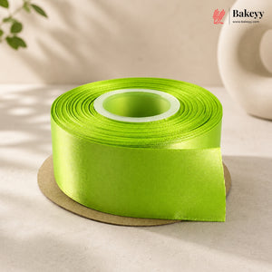 Roll of green ribbon on a beige surface with 'Bakeyy' branding.