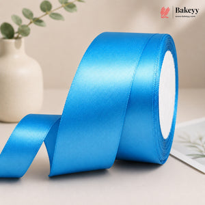 Roll of blue satin ribbon with a beige background and 'Bakeyy' branding.