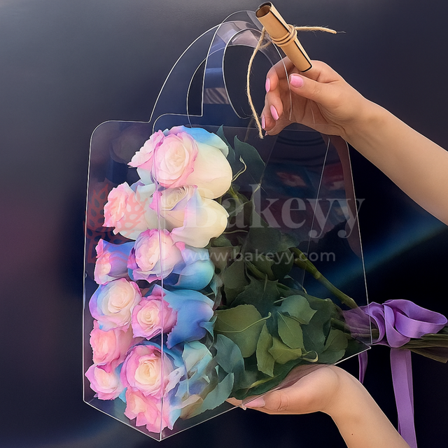 Transparent bag with colorful roses and green leaves held by a hand against a dark background.