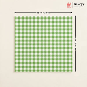 A square green and white gingham checkered tile or mat shown on a light beige background, with black dimension arrows indicating 18 cm by 18 cm (7 inches) and a Bakeey logo in the top right corner.