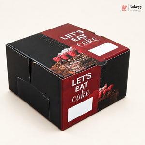 A square bakery box with a black and deep red design, featuring the text 'LET'S EAT cake' in white script over a chocolate cake and raspberry photo. A small Bakeyy logo appears in the top right corner.