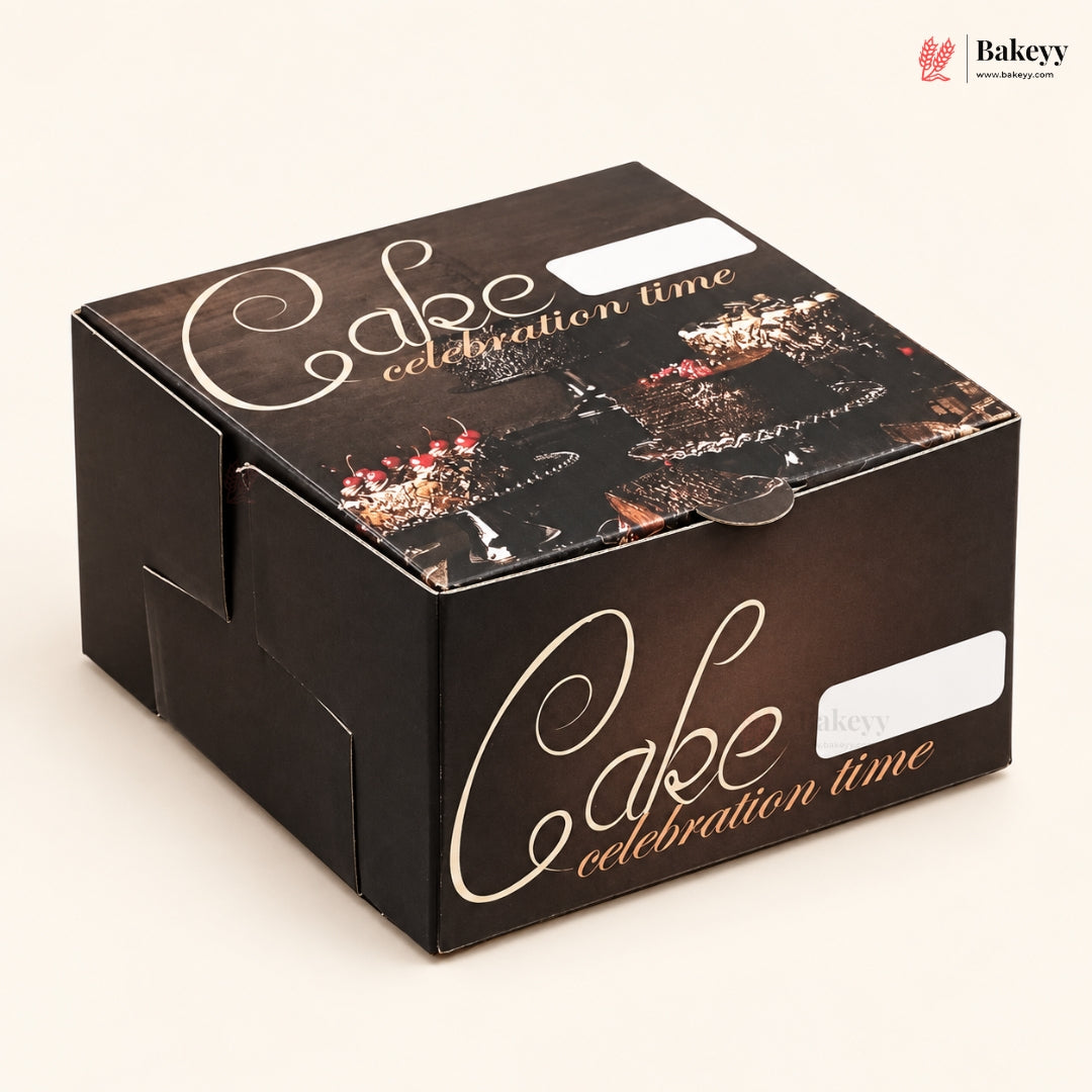 A square dark brown cardboard cake box with 'Cake celebration time' printed in white and gold script, decorated with a chocolate cake illustration on the lid, photographed on a light beige background.