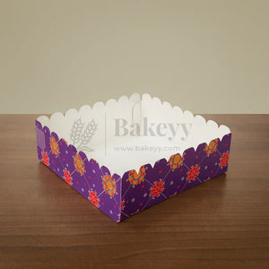 Decorative purple box with floral patterns on a wooden surface, branded 'Bakeyy'.