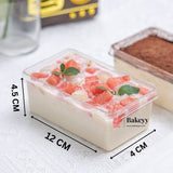 Rectangular cake with fruit toppings in a clear container, dimensions shown, with Bakeyy logo.