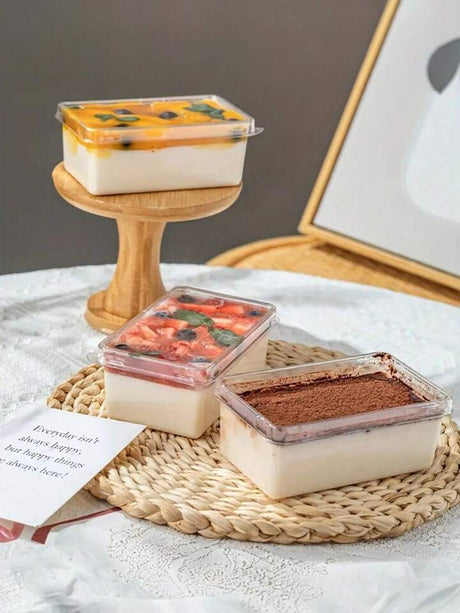 Three small containers of different desserts on a woven mat with a neutral background