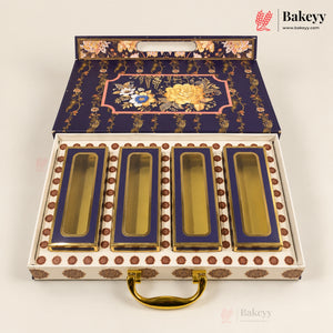 An ornate open gift box containing four rectangular glass jars with gold-toned lids and deep blue interiors. The box lid and base are decorated with gold floral motifs and brown circular accents, and the set is photographed on a clean white background.