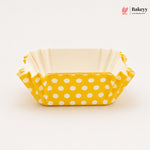 Yellow polka dot baking tray with beige interior on a white background, featuring the Bakeyy brand.