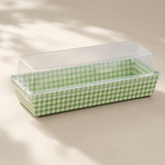 Rectangular baking dish with green checkered pattern on a beige surface