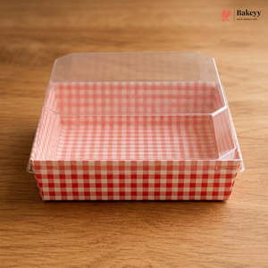Clear plastic container with red and white checkered interior on a wooden surface, featuring the Bakey brand.