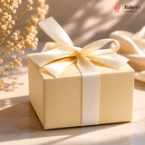Beige gift box with a white ribbon on a light background, featuring the brand 'Bakeyy'.