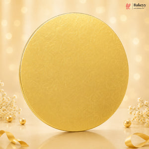 Gold round cake board with decorative elements on a beige background