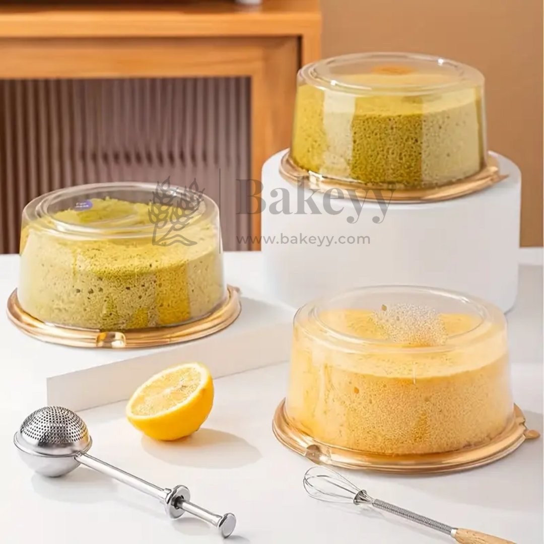 Three cakes in clear cake stands on a white surface with a lemon and kitchen tools, branded 'Bakey'.