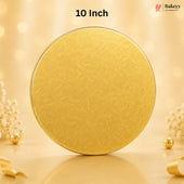 A round gold-colored tin with a subtle embossed floral pattern, standing upright on a reflective surface. The background is a warm, soft beige with bokeh lights and decorative pearl-like flowers.