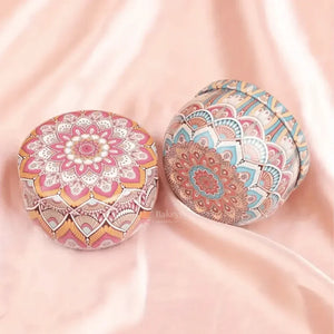 Round mandala print tin boxes for gift packaging from Bakeyy on pink silk background