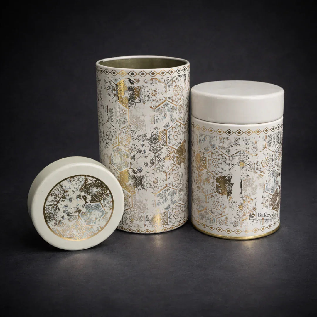 Round metal tin gift boxes with gold and white geometric design from Bakeyy wholesale shop