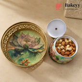 A decorative ceramic nut and candy jar with a matching lid, shown open with almonds inside. The jar has a floral lotus design in soft green, pink, and gold tones, with a gold-tone perforated rim.