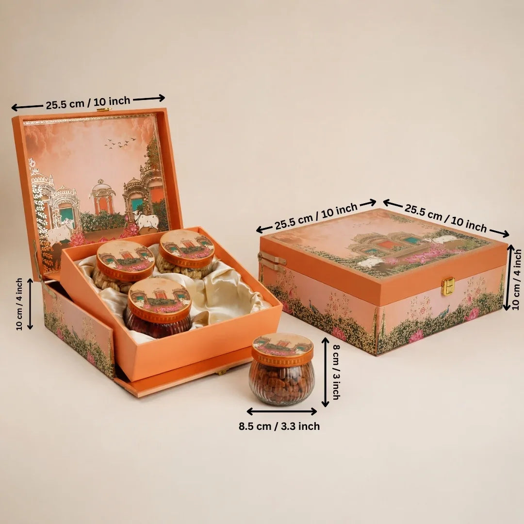 An orange decorative gift box set with three small jars of nuts, shown open and closed with dimension arrows and labels indicating measurements of 25.5 cm by 10 cm.