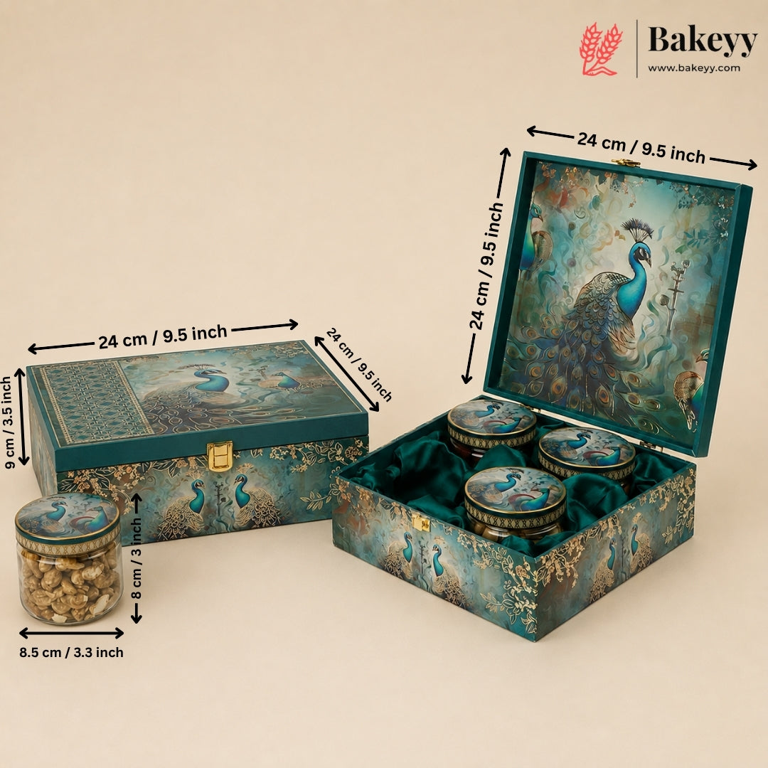 Decorative teal and gold peacock-themed gift box set with three round jars, shown closed and open with dimension arrows and labels. The Bakeyy logo appears in the top right corner.