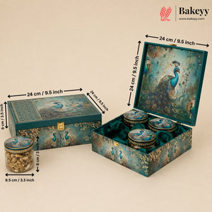 Decorative teal and gold peacock-themed gift box set with three round jars, shown closed and open with dimension arrows and labels. The Bakeyy logo appears in the top right corner.