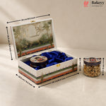 A decorative rectangular gift box with a tropical landscape print on the lid and sides, lined with blue velvet, shown open with dimension arrows and labels indicating 24 cm by 16.5 cm by 9 cm.