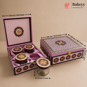 Decorative pink and purple gift box set with four small round jars, shown open and closed with dimension arrows and labels. The Bakeyy logo appears in the top right corner.