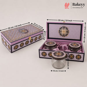Decorative purple and gold ceramic tea set with a matching storage box, shown closed and open with dimension labels. The set includes a glass jar with a purple lid, two small ceramic jars with purple lids, and a larger open box containing the jars, all on a light gray background with Bakeyy branding.