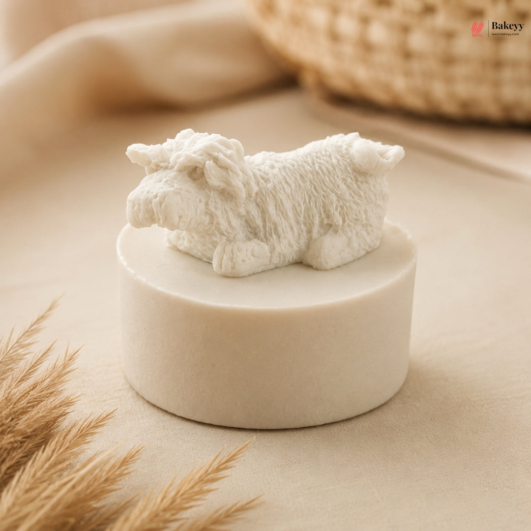 White sheep figurine on a beige pedestal with a blurred background
