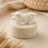 White sheep figurine on a beige pedestal with a blurred background