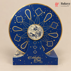 A round blue and gold moon phase display stand with a central moon window, shown on a matching branded base against a beige background. The Bakeyy logo appears in the top right corner.