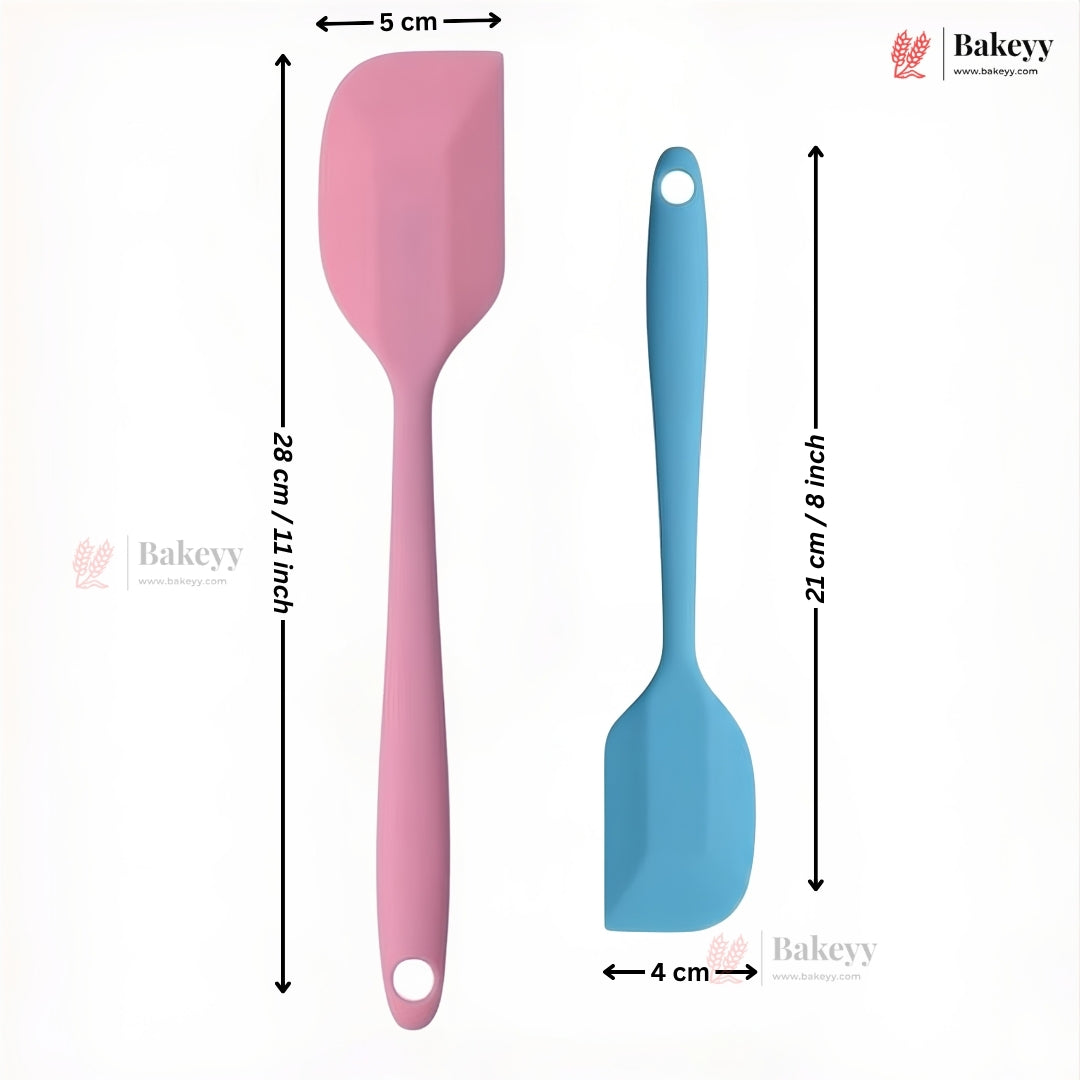 Two silicone spatulas, one pink and one blue, with measurements on a white background. Brand 'Bakeyy' is visible.