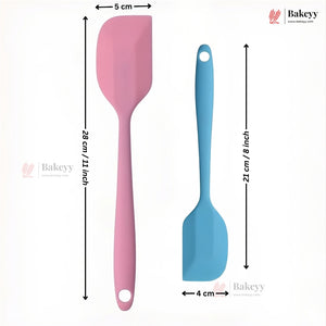 Two silicone spatulas, one pink and one blue, with measurements on a white background. Brand 'Bakeyy' is visible.