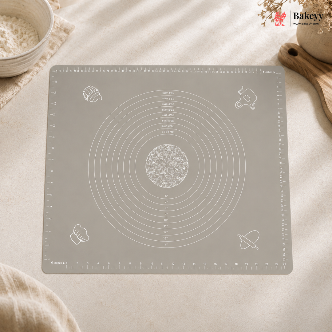 Gray baking mat with measurement markings on a light surface, featuring the Bakey brand.