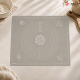 Gray baking mat with measurement markings on a light surface, featuring the Bakey brand.