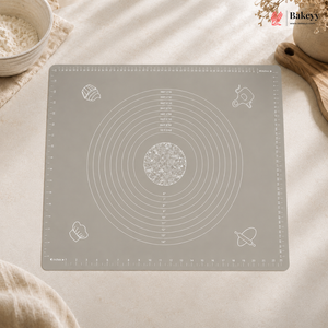 Gray baking mat with measurement markings on a light surface, featuring the Bakey brand.
