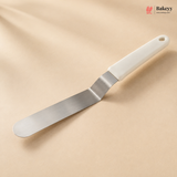 Spatula with white handle on a beige background, featuring the Bakeey brand.