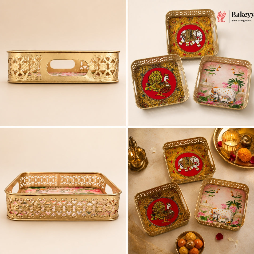 A 2x2 collage showing gold-toned decorative trays and coasters with ornate cutout patterns and printed animal motifs, including a tiger, peacock, and elephant, on a warm beige background. The Bakeey logo appears in the top right.