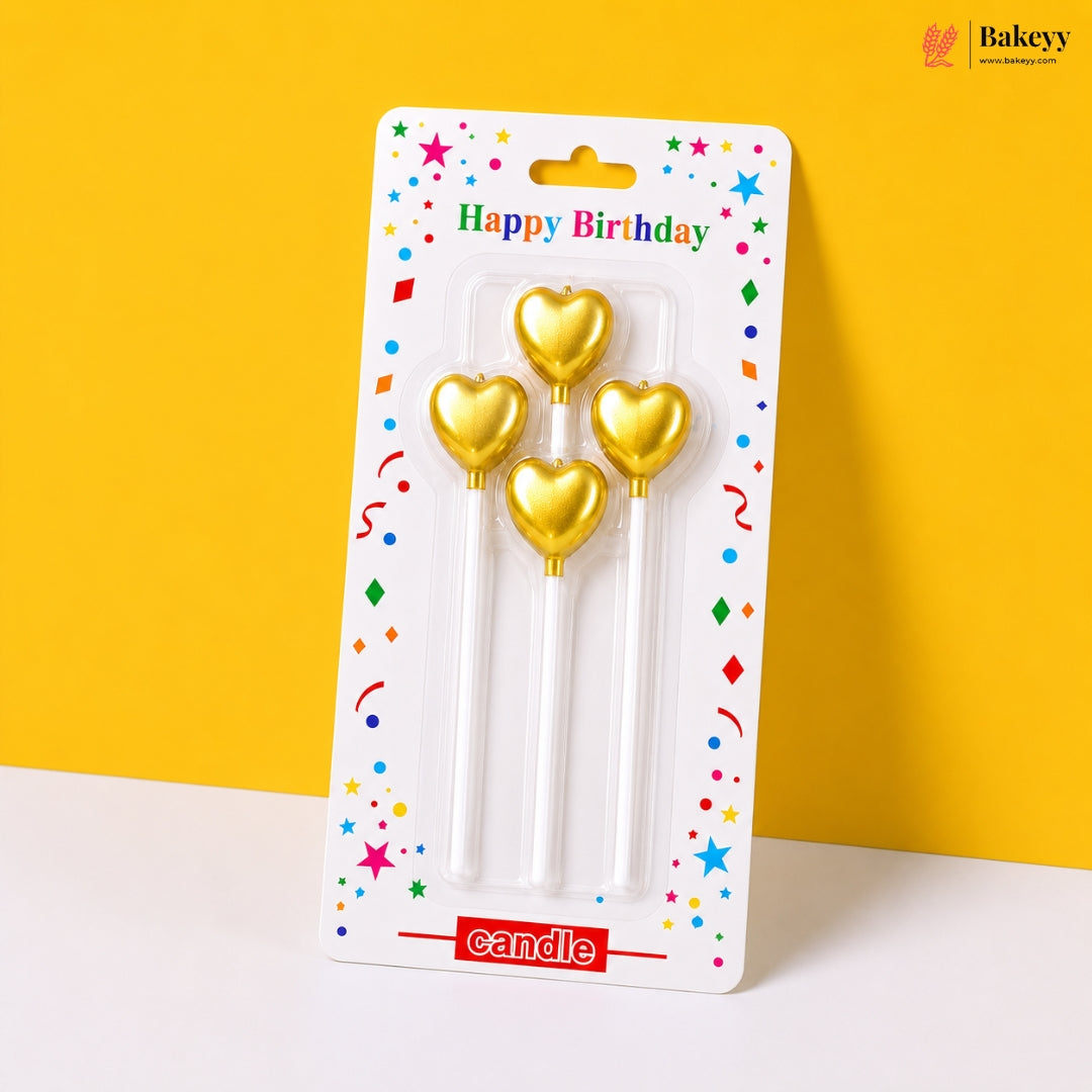 Gold heart-shaped candles in packaging with 'Happy Birthday' text on a yellow background
