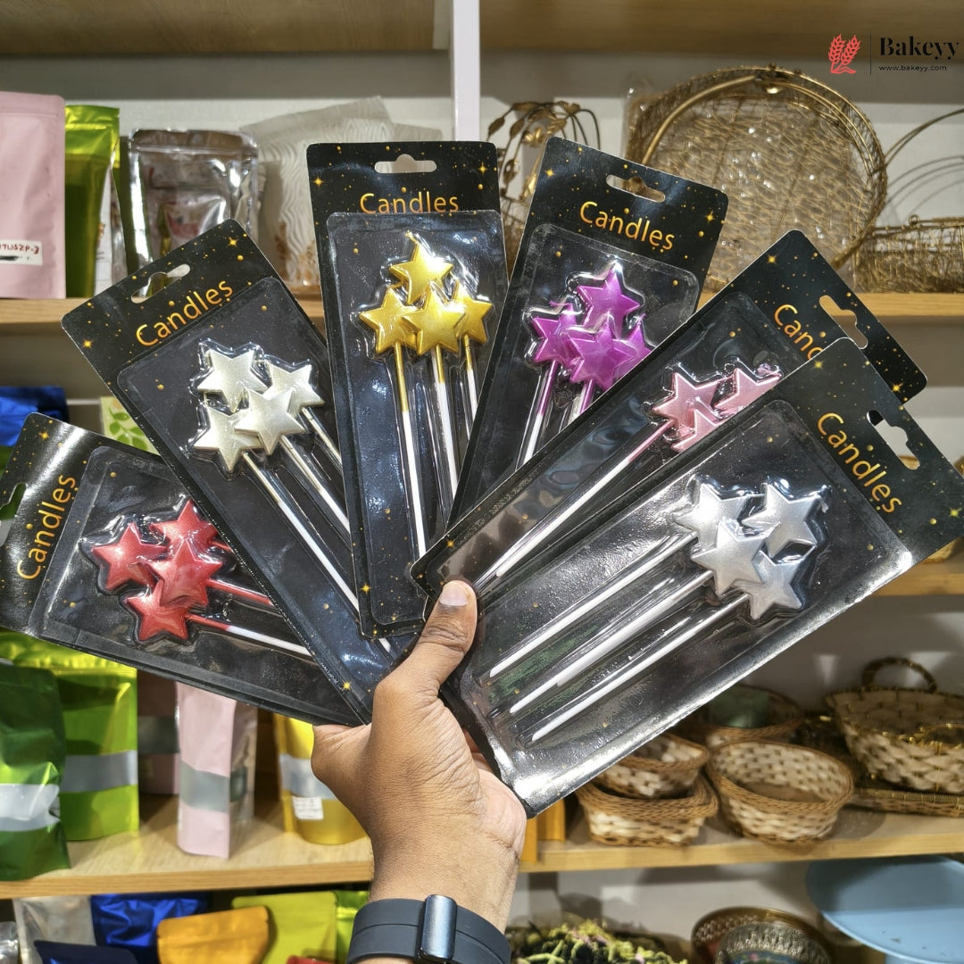 Hand holding packages of star-shaped candles with a store shelf in the background