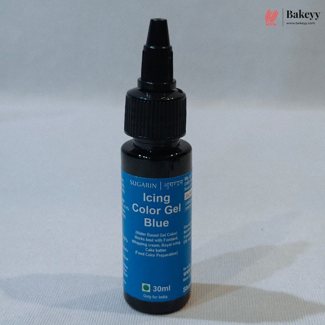A 30ml bottle of Sugarin Icing Color Gel in the shade Blue, featuring a black dropper cap and a blue label, set against a neutral gray background.