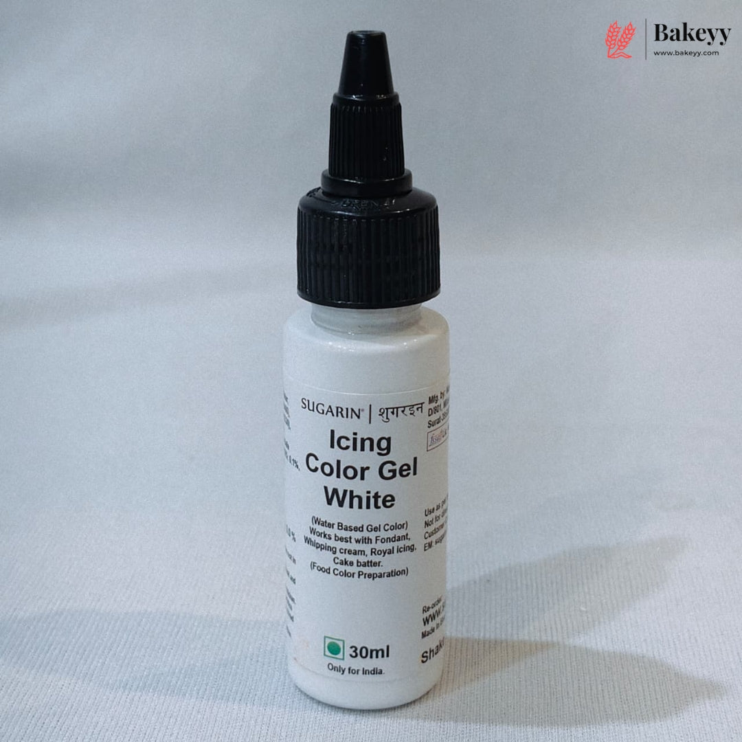 A 30ml bottle of Sugararin Icing Color Gel White, featuring a white plastic bottle, black cap, and black text on the label, set against a light gray fabric background.